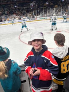 Luke Kunin, T1D NHL player, tosses T1T attendee a puck when he sees his jersey in the stands,